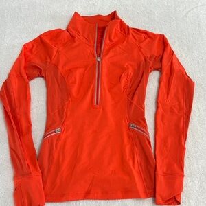 Lululemon Athletica Women's Orange 3/4 zip vented running pullover.